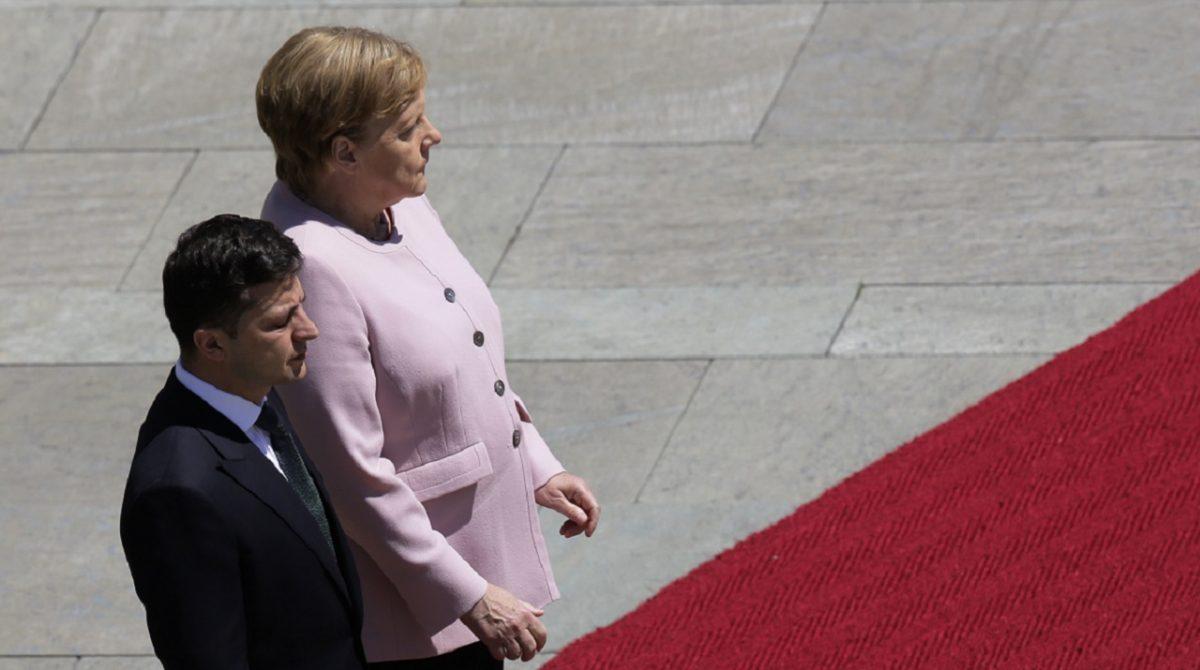 German Chancellor Angela Merkel (R) and Ukrainian President Volodymyr Zelenskiy listen to the national anthems during the welcoming ceremony, prior to a meeting at the chancellery in Berlin, Germany, on June 18, 2019. (Markus Schreiber/AP Photo)