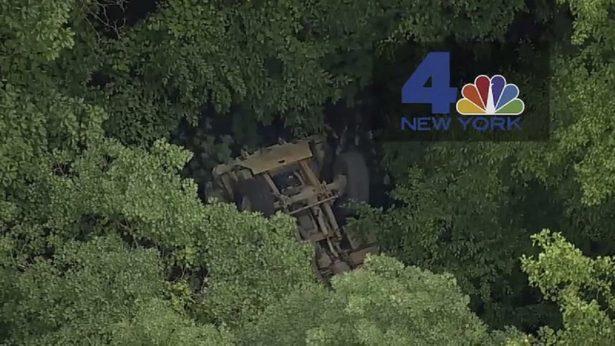 A light medium tactical vehicle sits overturned near the Camp Natural Bridge summer military training camp off Route 293, in Cornwall, N.Y., on June 6, 2019. (NBC New York via AP)