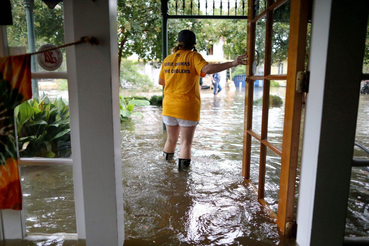Robyn Iacona-Hilbert stands outside her flooded business after Hurricane Barry in Mandeville, Louisiana, U.S., on July 13, 2019. (Jonathan Bachman/Reuters)