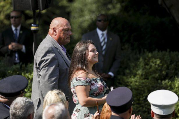 Family members of deceased NYPD officer James Zadroga attend President Donald Trump's signing of the 9/11 Victim Compensation Fund bill in the White House Rose Garden on July 29, 2019. (Charlotte Cuthbertson/The Epoch Times)