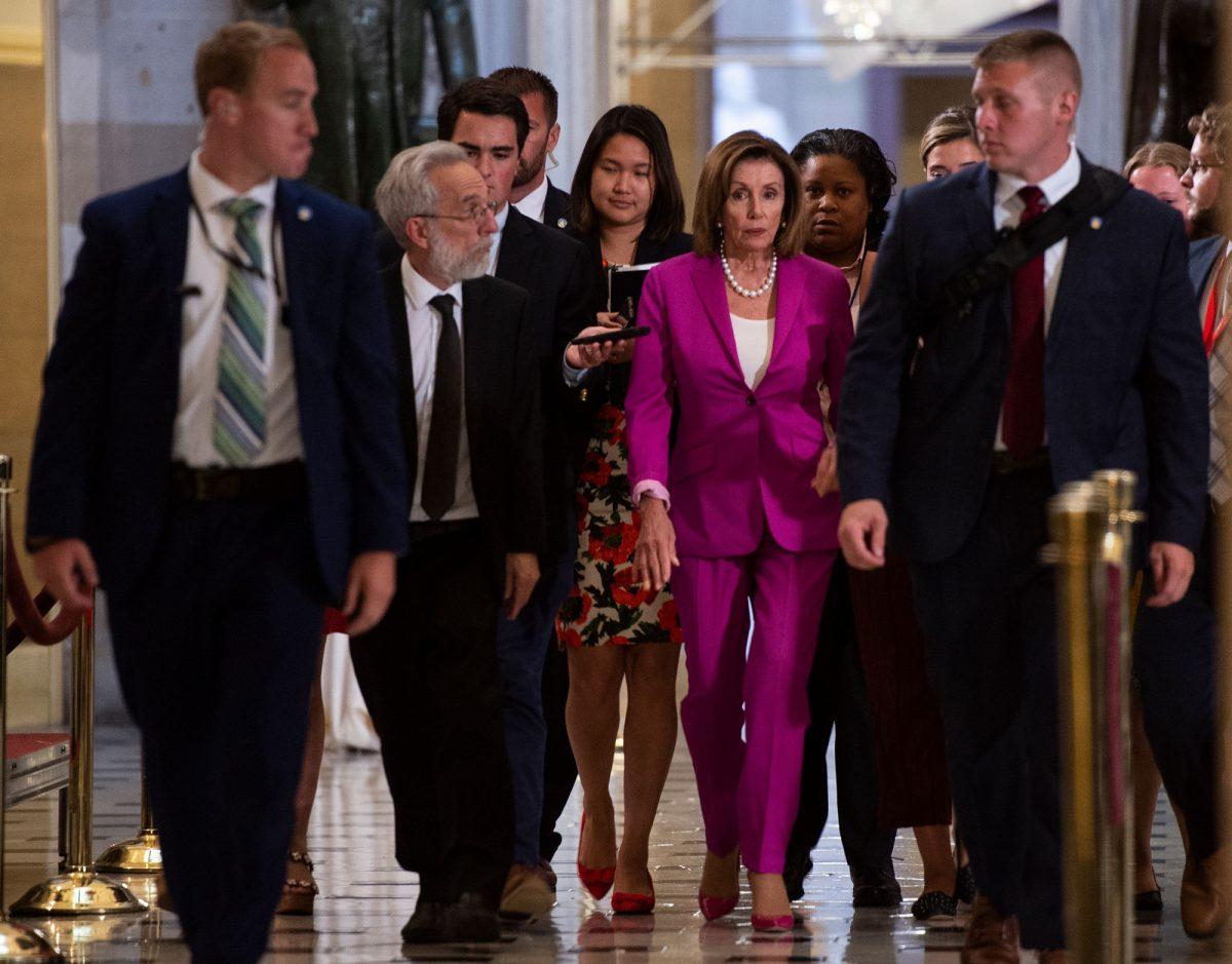 Speaker of the House Nancy Pelosi (D-Calif.) walks with reporters, before the Democrat-controlled House of Representatives passed a resolution condemning President Donald Trump for his "racist comments" at the U.S. Capitol in Washington on July 16, 2019. (Andrew Caballero-Reynolds/AFP/Getty Images)