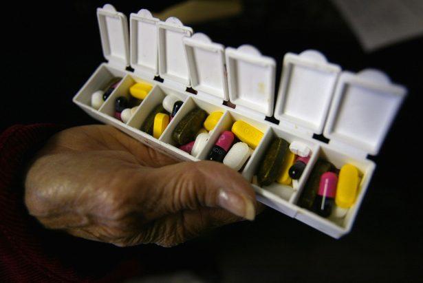 A woman displays a box of pills for her asthma and high blood pressure condition purchased in Canada at a 58.9 percent savings rate in a file photo in New York City. (Photo by Spencer Platt/Getty Images)