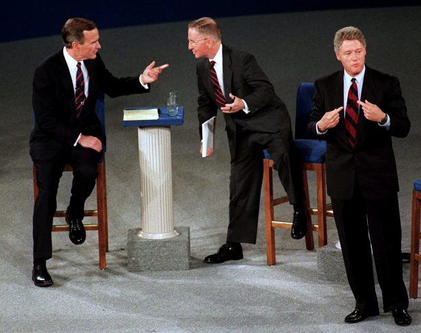 Former President George H.W. Bush, left, talks with independent candidate Ross Perot as Democratic candidate Bill Clinton stands aside at the end of their second presidential debate in Richmond, Va., on Oct. 15, 1992. (Marcy Nighswander/File Photo/AP)