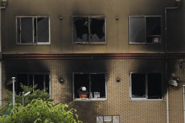 An investigator takes pictures inside the Kyoto Animation Studio building destroyed in an arson attack in Kyoto, Japan, on July 19, 2019. (Jae C. Hong/AP Photo)