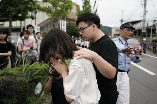 A woman prays to honor the victims of Thursday's fire at the Kyoto Animation Studio building, in Kyoto, Japan, on July 19, 2019. (Jae C. Hong/AP Photo)