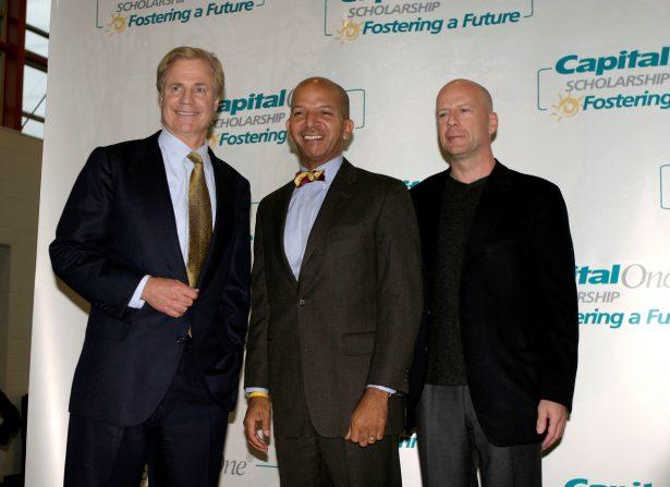 Capitol One Founder and CEO, Richard Fairbank (L), District of Columbia Mayor Anthony Williams (C), and actor Bruce Willis pose for a photo in Washington, on Dec. 6, 2004. (Shaun Heasley/Getty Images)