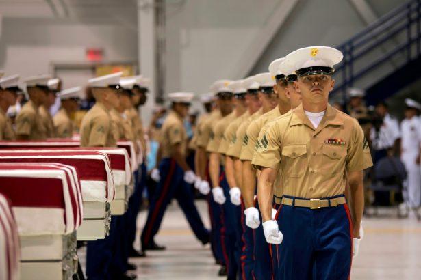 Marines march past transfer cases holding the possible remains of unidentified service members lost in the Battle of Tarawa on July 17, 2019. (Sgt. Jacqueline Clifford/U.S. Marine Corps via AP)