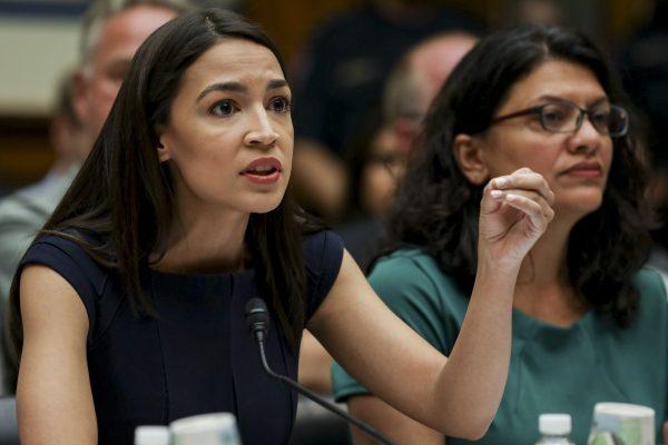 Reps. Alexandria Ocasio-Cortez (D-N.Y.) (L) and Rashida Tlaib (D-Mich.) at a House hearing in front of the Committee on Oversight and Reform, in Washington on July 12, 2019. (Charlotte Cuthbertson/The Epoch Times)