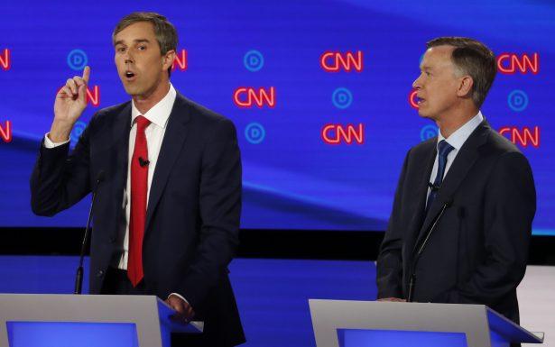 Former Texas Rep. Beto O'Rourke (D-Texas) speaks as former Colorado Gov. John Hickenlooper listens during the first of two Democratic presidential primary debates hosted by CNN in the Fox Theatre in Detroit, Michigan on July 30, 2019. (AP Photo/Paul Sancya)