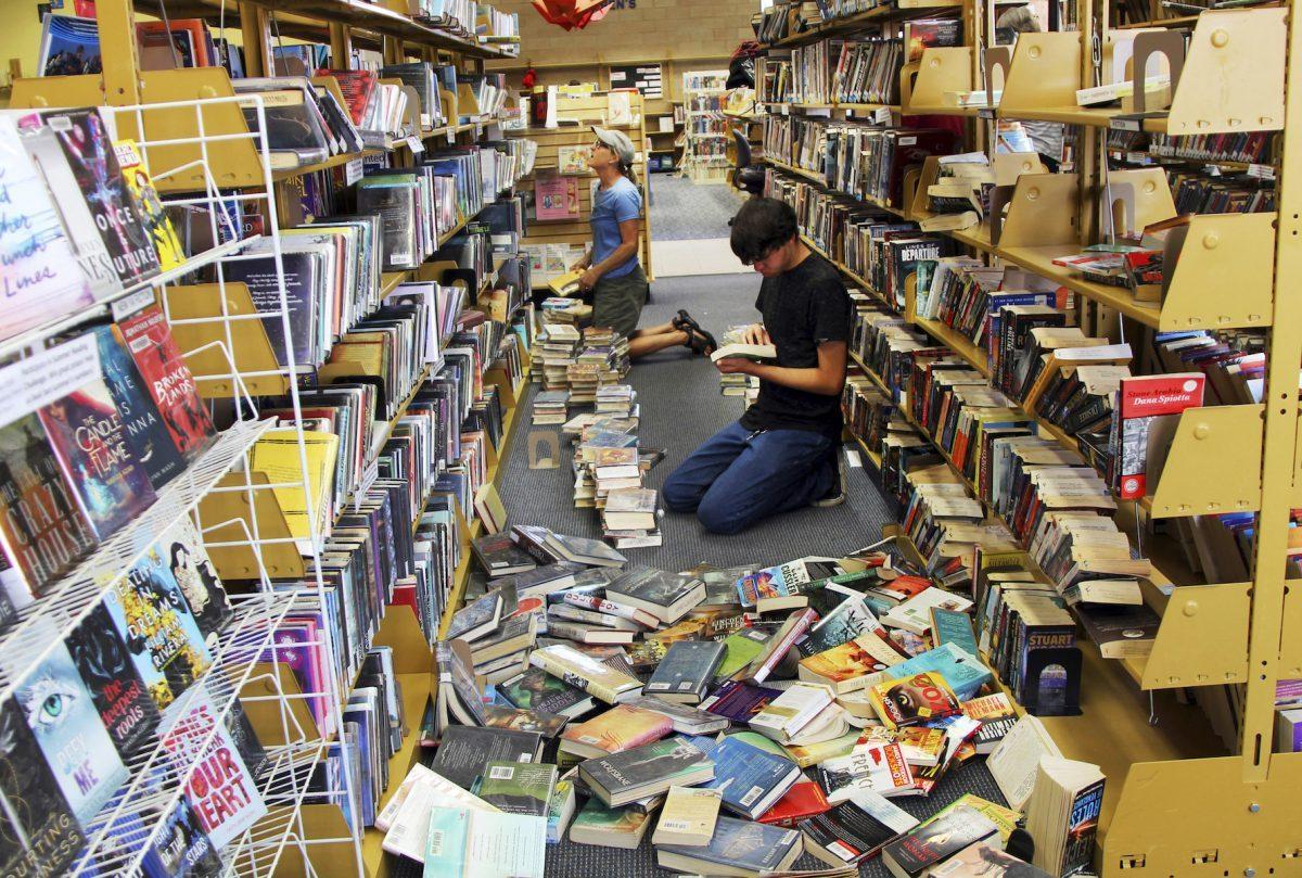 Volunteers assist with cleanup following a 6.4 magnitude earthquake at the Ridgecrest, Calif., branch of the Kern County Library on July 5, 2019. (Jessica Weston/Daily Independent via AP)