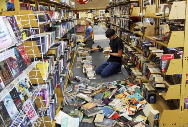 Volunteers assist with cleanup at the Ridgecrest, Calif., branch of the Kern County Library on Friday, July 5, 2019, following a 6.4 magnitude earthquake that shook the region about 150 miles northeast of Los Angeles Thursday. (Jessica Weston/Daily Independent via AP)