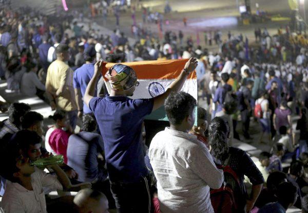 An Indian spectator folds a flag as others leave after the Chandrayaan-2 mission was aborted at Sriharikota, in southern India, on July 15, 2019. (Manish Swarup/AP Photo)