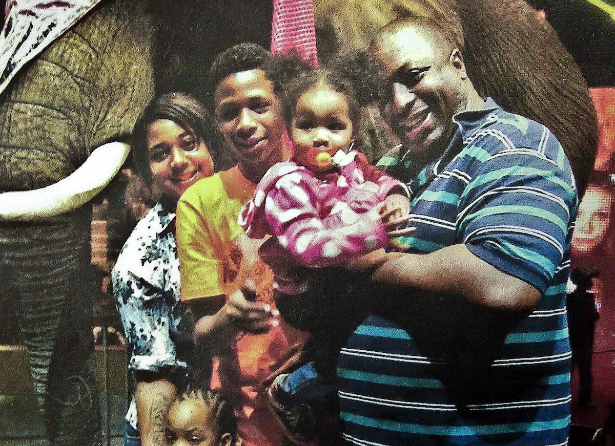 Eric Garner (R) poses with his children during a family outing. (Family photo via National Action Network/AP Photo)