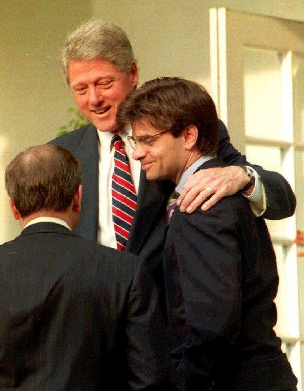 President Bill Clinton (C) speaks to White House Chief of Staff Thomas McLarty (L) on May 29, 1993, with his arm around George Stephanopoulos (R) in the Rose Garden of the White House. (Jennifer Law/AFP via Getty Images)