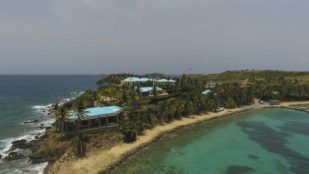 A video frame grab shows an aerial view of Little Saint James Island, in the U. S. Virgin Islands, owned by Jeffrey Epstein. Epstein built on the island a stone mansion with cream-colored walls and a bright turquoise roof surrounded by several other structures including the maids’ quarters and a massive, square-shaped white building on one end of the island. (AP Photo/Gianfranco Gaglione)