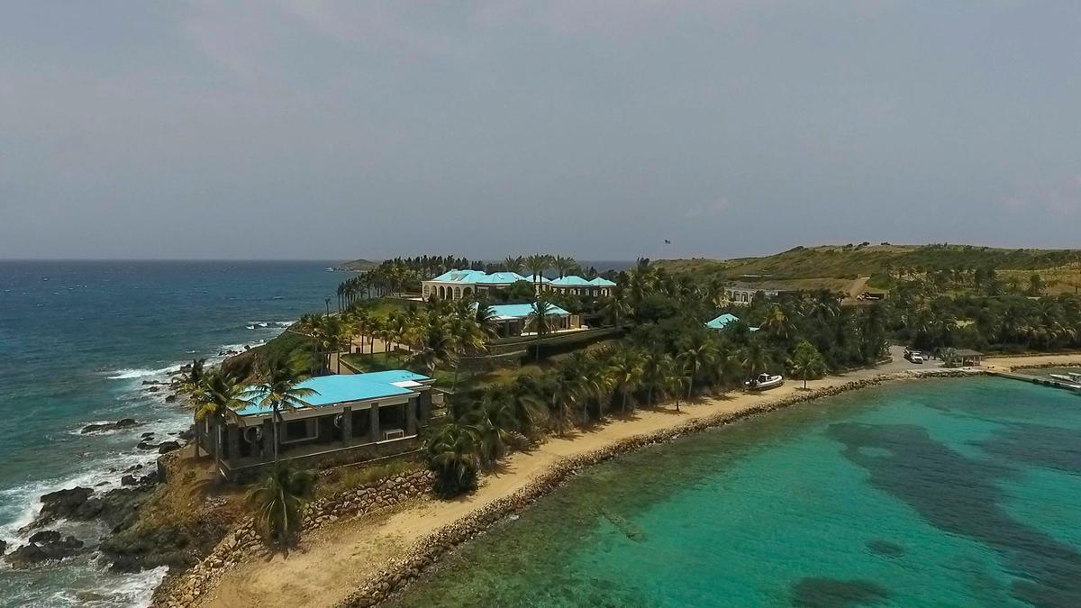 A video frame grab shows an aerial view of Little Saint James Island, in the U. S. Virgin Islands, owned by Jeffrey Epstein. Epstein built on the island a stone mansion with cream-colored walls and a bright turquoise roof surrounded by several other structures including the maids’ quarters and a massive, square-shaped white building on one end of the island. (Gianfranco Gaglione/AP Photo)