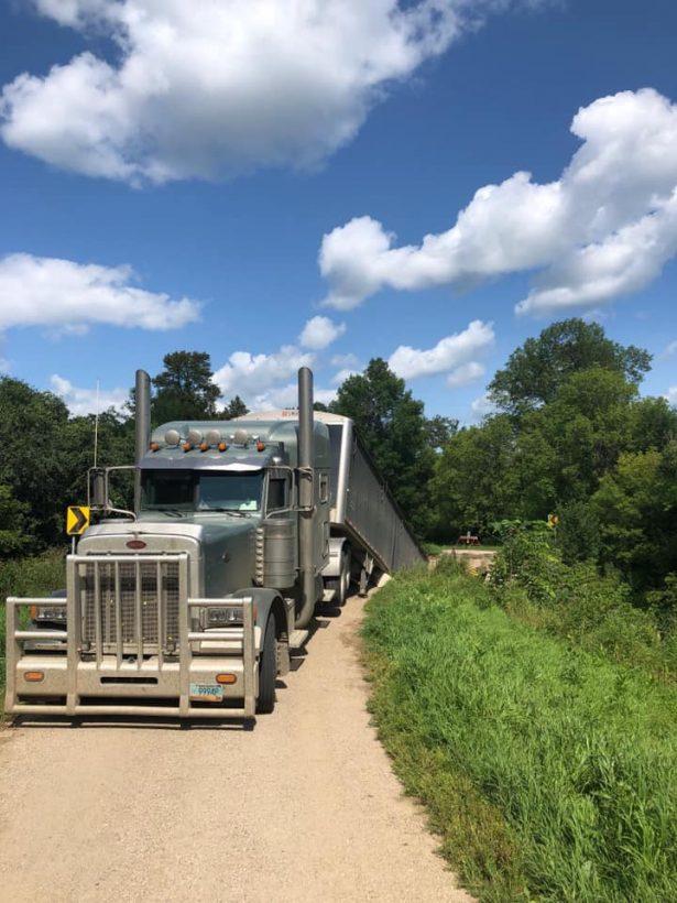 A photo provided by Grand Forks County Sheriff's Department shows an overweight semi has caused the collapse of a small, historic bridge near Northwood, N.D. on July 22, 2019. (Grand Forks County Sheriff's Department via AP)