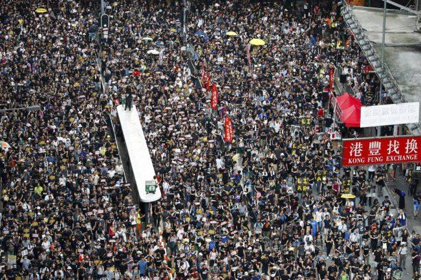 Protesters take part in a march on a street in Hong Kong, on July 21, 2019. (Vincent Yu/AP Photo)