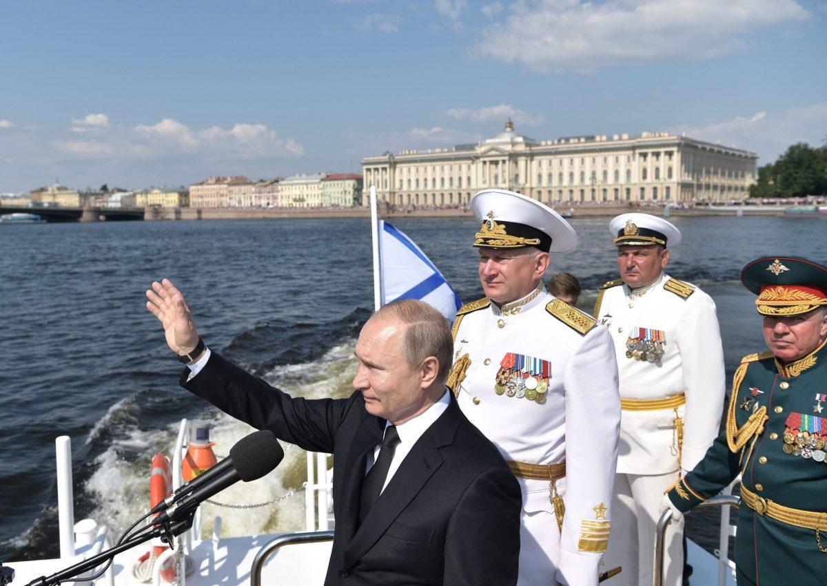 Russian President Vladimir Putin, foreground, and Commander-in-Chief of the Russian Navy Nikolai Yevmenov, third right, arrive to attend the military parade during the Navy Day celebration in St.Petersburg, Russia, on July 28, 2019. (Alexei Nikolsky, Sputnik, Kremlin Pool Photo via AP)