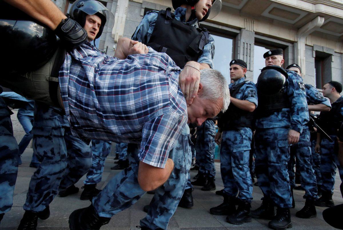 Law enforcement officers detain a participant of a rally calling for opposition candidates to be registered for elections to Moscow City Duma, the capital's regional parliament, in Moscow, Russia, on July 27, 2019. (Maxim Shemetov/Reuters)