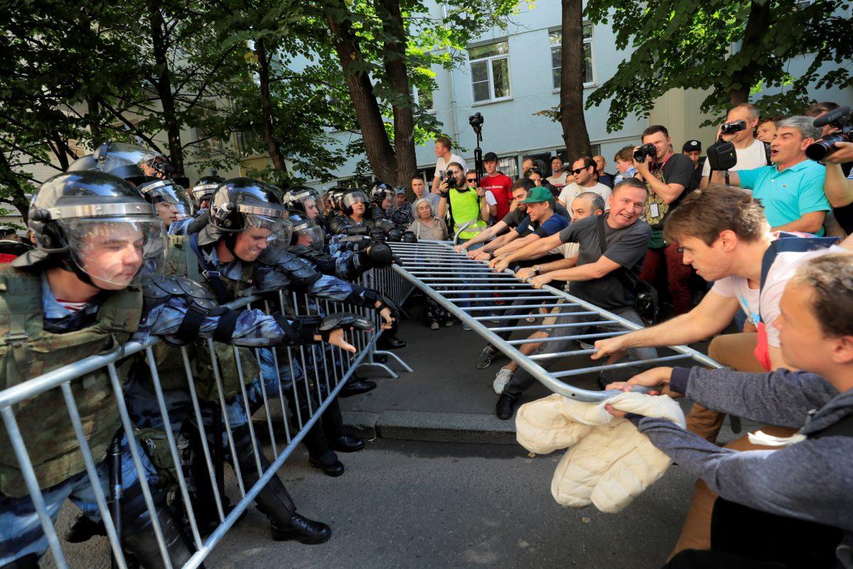 Protesters attempt to remove fences during a rally calling for opposition candidates to be registered for elections to Moscow City Duma, the capital's regional parliament, in Moscow, Russia, on July 27, 2019. (Tatyana Makeyeva/Reuters)