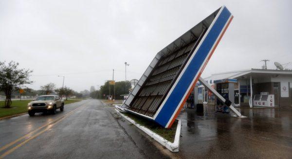 A vehicle passes a toppled gas pump canopy in Berwick, La., following a severe weather assault from Tropical Storm Barry, on July 13, 2019. (Rogelio V. Solis/AP Photo)