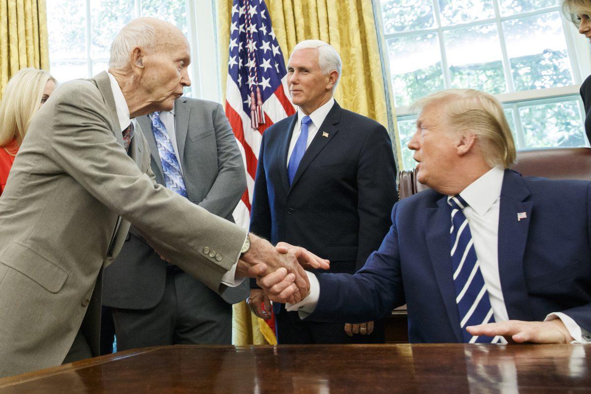 President Donald Trump shakes hands with Apollo 11 astronaut Micheal Collins, left, with Vice President Mike Pence, during a photo opportunity commemorating the 50th anniversary of the Apollo 11 moon landing, in the Oval Office of the White House, in Washington, on July 19, 2019. (AP Photo/Alex Brandon)