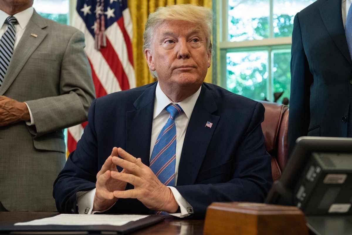 President Donald Trump speaks to the press before signing a bill for border funding legislation in the Oval Office at the White House on July 1, 2019. (Nicholas Kamm/AFP/Getty Images)