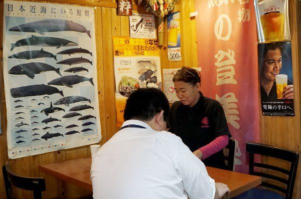 Tsukiji's whale meat restaurant Tomisui manager Sumiko Koizumi (R) talking with whale meat dealer at her restaurant in Tokyo, on July 2, 2019. (Karyn Nishimura/AFP/Getty Images)