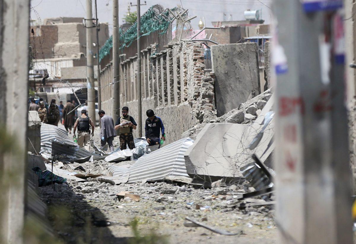 Members of Afghan security forces inspect the site of a car bomb blast in Kabul, Afghanistan on Aug. 7, 2019. (Omar Sobhani/Reuters)