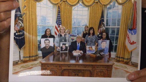 Agnes Gibboney shows a photo of her with other Angel families meeting President Trump at the White House, on Aug. 7, 2019. (Annie Wang/NTD)