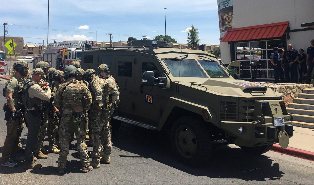 Armed Policemen gather next to an FBI armoured vehicle next to the Cielo Vista Mall as an active shooter situation is going inside the Mall in El Paso, Texas, on Aug. 3, 2019. (Joel Angel Juarez/AFP/Getty Images)