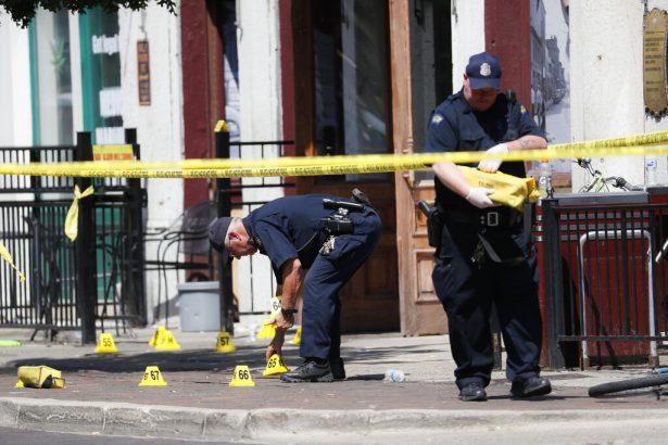 Authorities retrieve evidence markers at the scene of the mass shooting in Dayton, Ohio, on Aug. 4, 2019. (John Minchillo/AP Photo)