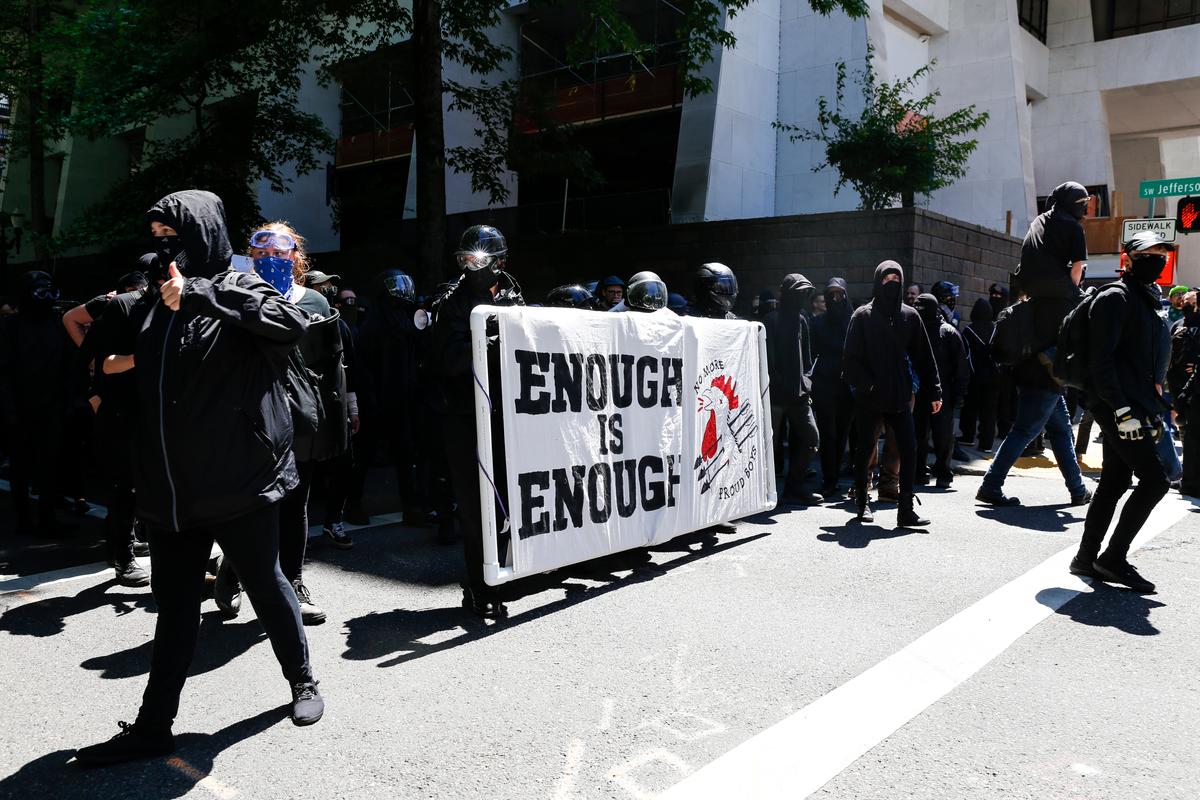 The Rose City Antifa prepare to march in opposition to members of HimToo and Proud Boys on June 29, 2019 in Portland, Oregon. Several groups from the left and right clashed after competing demonstrations at Pioneer Square, Chapman Square, and Waterfront Park spilled into the streets. According to police, medics treated eight people and three people were arrested during the demonstrations. (Moriah Ratner/Getty Images)
