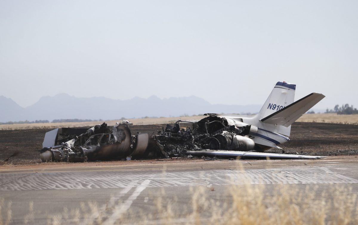 The burned out remains of a twin-engine Cessna Citation sits at the end of a runway after the pilot aborted the takeoff at the Oroville Airport in Oroville, Calif., on Aug. 21, 2019. (AP Photo/Rich Pedroncelli)