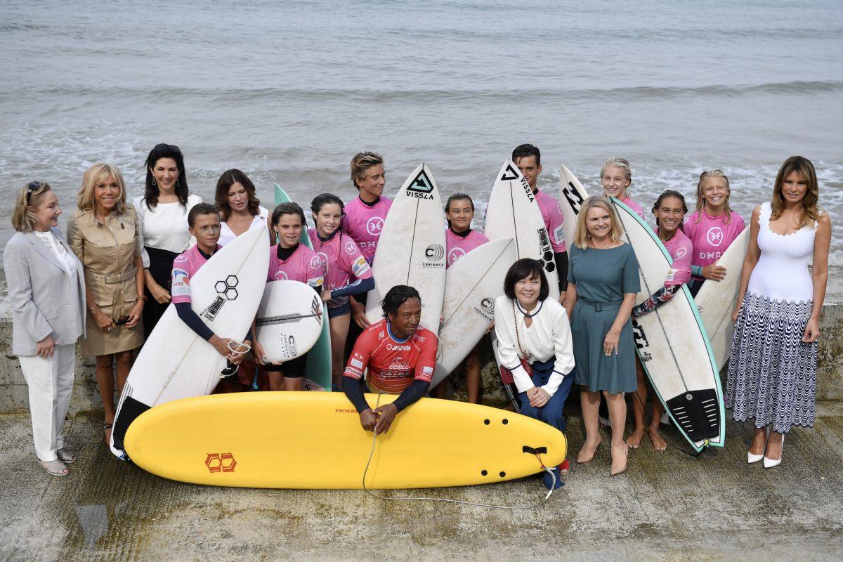 Chile's First Lady Cecilia Morel (L), French President's wife Brigitte Macron (2nd L), President of the World Bank Group's wife Adele Malpass, Australia's Prime Minister's wife Jenny Morrison (3rd L), Japan's Prime Minister's wife Akie Abe (3rd R), European Council President's wife Malgorzata Tusk (2nd R) and US First Lady Melania Trump (R) with surf students during a meeting with surfers at the Cote des Basques beach as part of the G7 summit, in Biarritz, France on Aug. 26, 2019. (JULIEN DE ROSA/AFP/Getty Images)