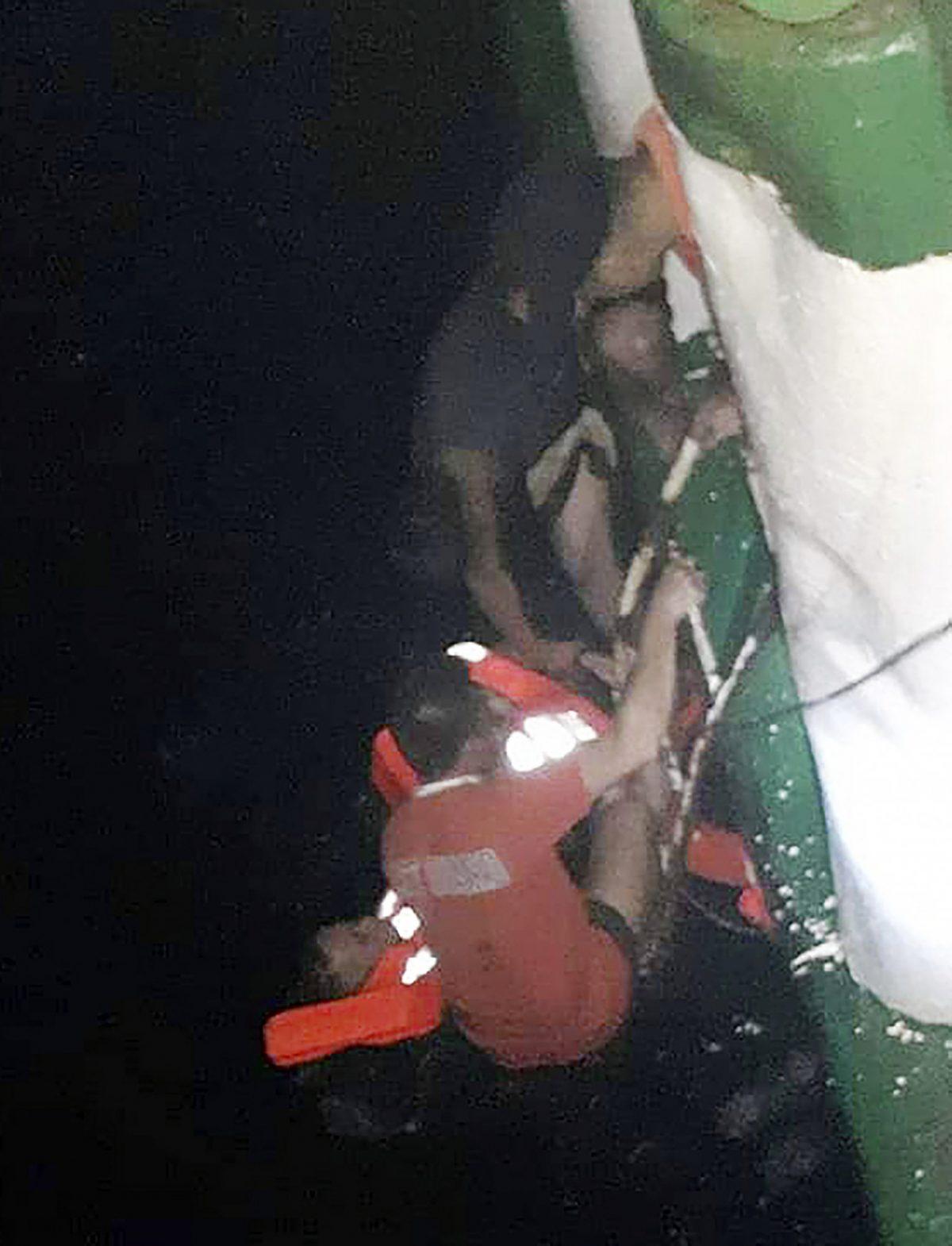 In this photo provided by Philippine Coast Guard in Manila, passengers are rescued by Philippine Coast Guard rescuers and crew of responding vessels from the M/V Lite Ferry 16 which caught fire before dawn on Aug. 28, 2019 off Dapitan city in Zamboanga del Norte province in the southern Philippines. (Philippine Coast Guard via AP)