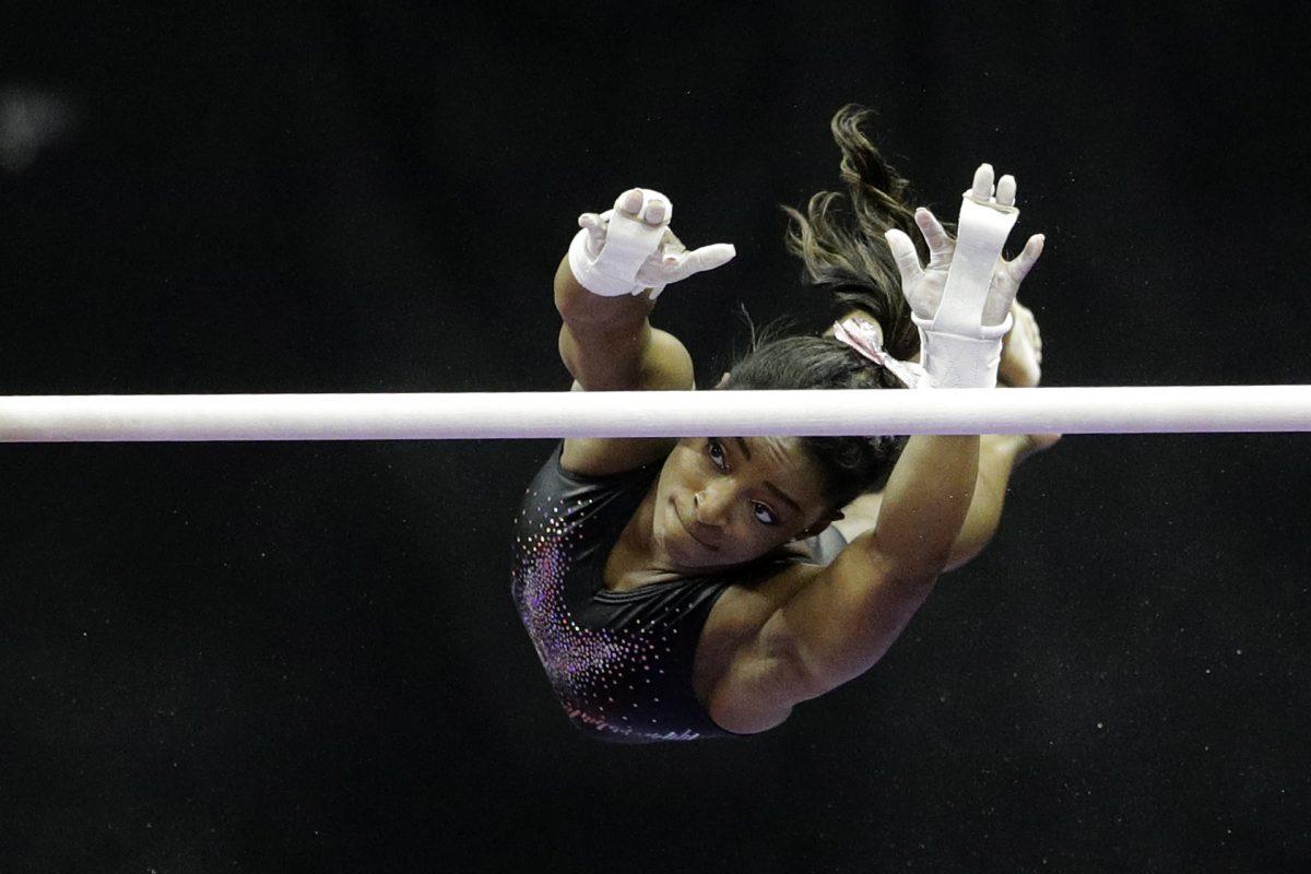 Simone Biles practices on the uneven bars for the senior women's competition at the 2019 U.S. Gymnastics Championships on Aug. 11, 2019, in Kansas City, Mo. (Charlie Riedel/AP Photo)