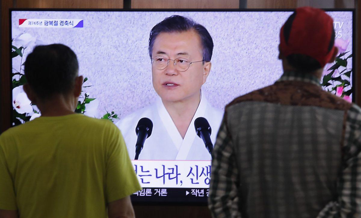 People watch a TV screen showing a live broadcast of South Korean President Moon Jae-in's speech during a ceremony to celebrate the Korean Liberation Day, marking the 74th anniversary of Korea's liberation from the Japanese colonial rule, at the Seoul Railway Station in Seoul, South Korea, on Aug. 15, 2019. (Ahn Young-joon/AP Photo)