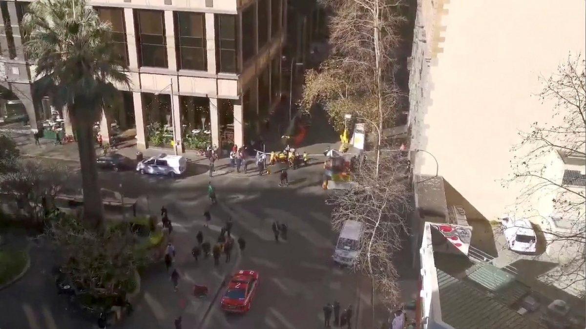 An aerial view shows security officers standing around a barricaded area, following reports of a stabbing incident in the central business district of Sydney, Australia on Aug. 13, 2019, in this still image from video obtained via social media. (Twitter @THEBORINGGIT via Reuters)