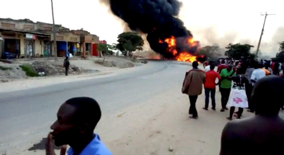 People look towards a fire following a fuel truck collision in Rubirizi, Uganda on Aug. 18, 2019 in this still image taken from social media video. (Nayebare Ediger via Reuters)