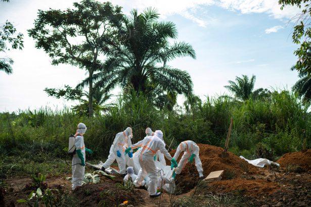 Workers bury the remains of Mussa Kathembo, an Islamic scholar who had prayed over those who were sick in Beni, Congo, on July 14, 2019. (Jerome Delay/AP Photo)