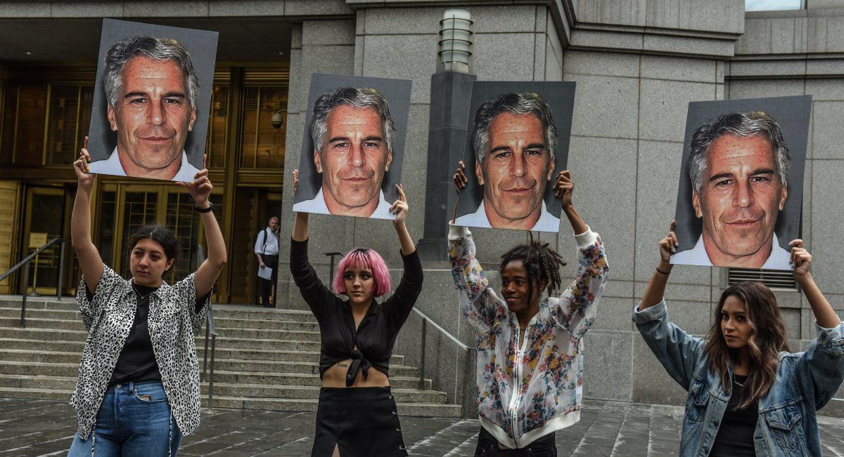 A protest group called "Hot Mess" hold up signs of Jeffrey Epstein in front of the Federal courthouse in the Manhattan borough of New York City on July 8, 2019. (Stephanie Keith/Getty Images)