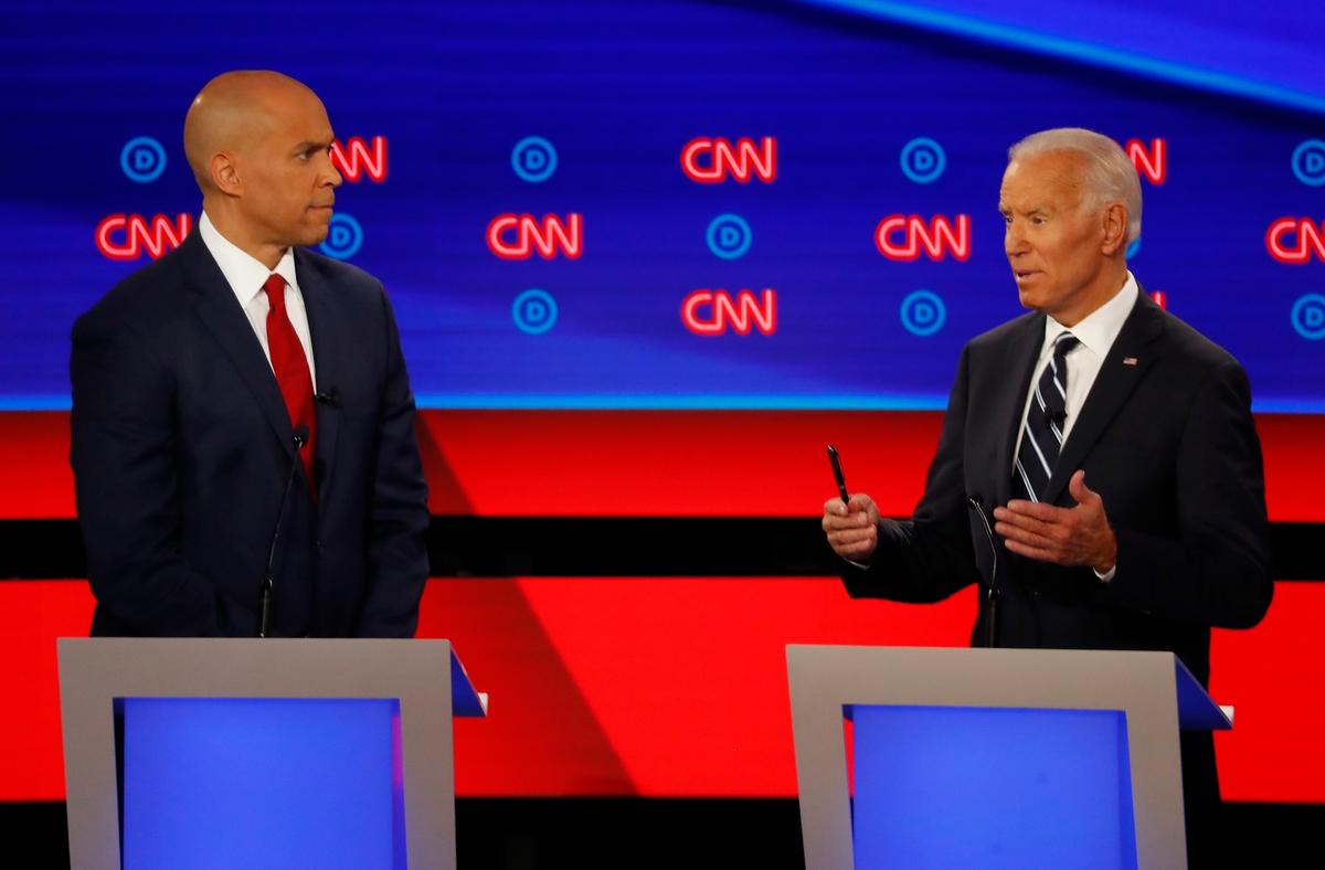 Sen. Cory Booker (D-N.J.) listens as former Vice President Joe Biden speaks during the second of two Democratic presidential primary debates hosted by CNN at the Fox Theatre in Detroit on July 31, 2019. (AP Photo/Paul Sancya)