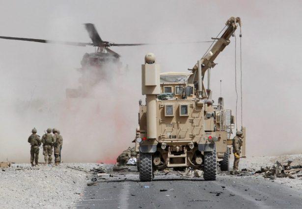 U.S. troops assess the damage to an armored vehicle of NATO-led military coalition after a suicide attack in Kandahar province, Afghanistan on Aug. 2, 2017. (Ahmad Nadeem/Reuters)