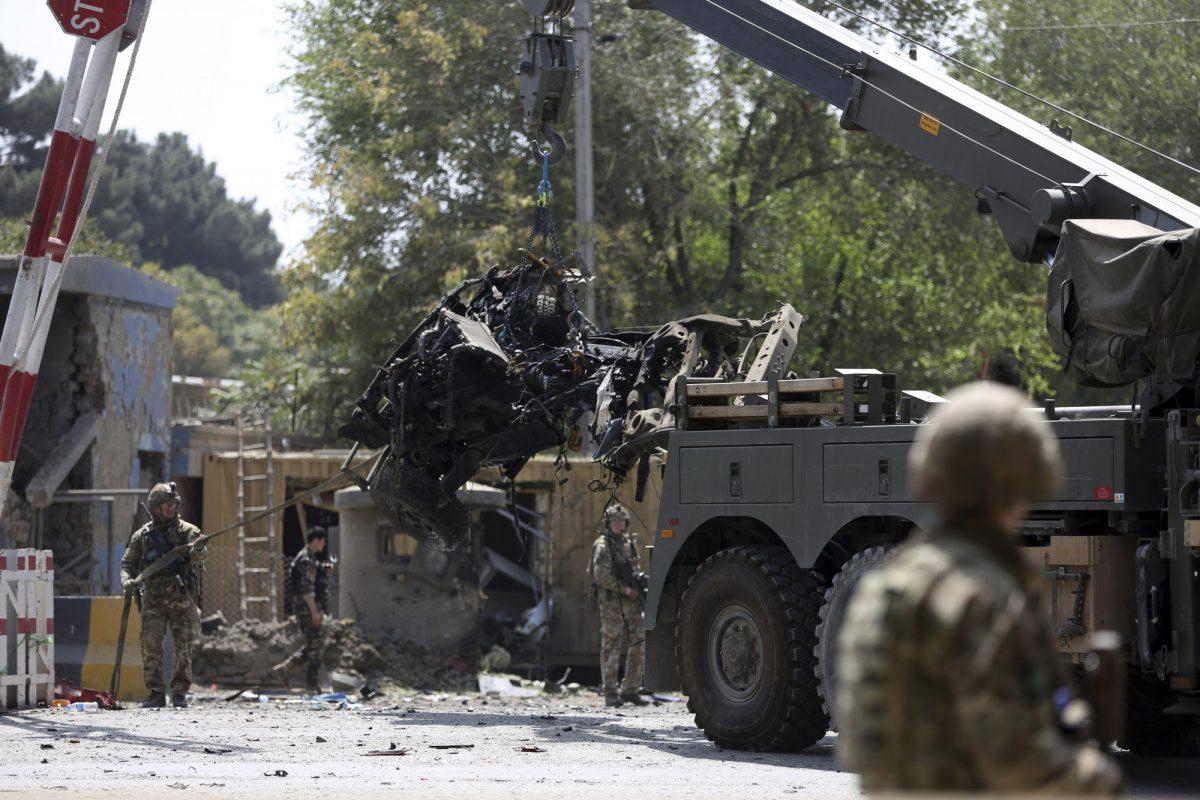 Resolute Support (RS) forces remove a damaged vehicle after a car bomb explosion in Kabul, Afghanistan on Sept. 5, 2019. (Rahmat Gul/AP Photo)