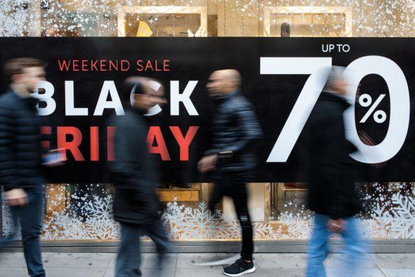 Shoppers walk past a Black Friday sale sign on Oxford Street on Nov. 24, 2017 in London, England. (Jack Taylor/Getty Images)