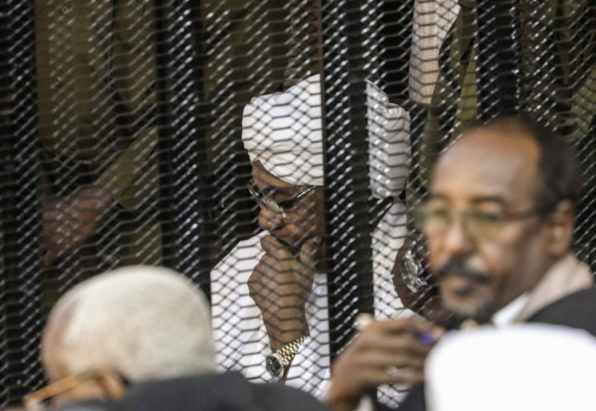 Sudan's autocratic former President Omar al-Bashir sits in a cage during his trial on corruption and money laundering charges, in Khartoum, Sudan on Aug. 24, 2019. (AP File Photo)