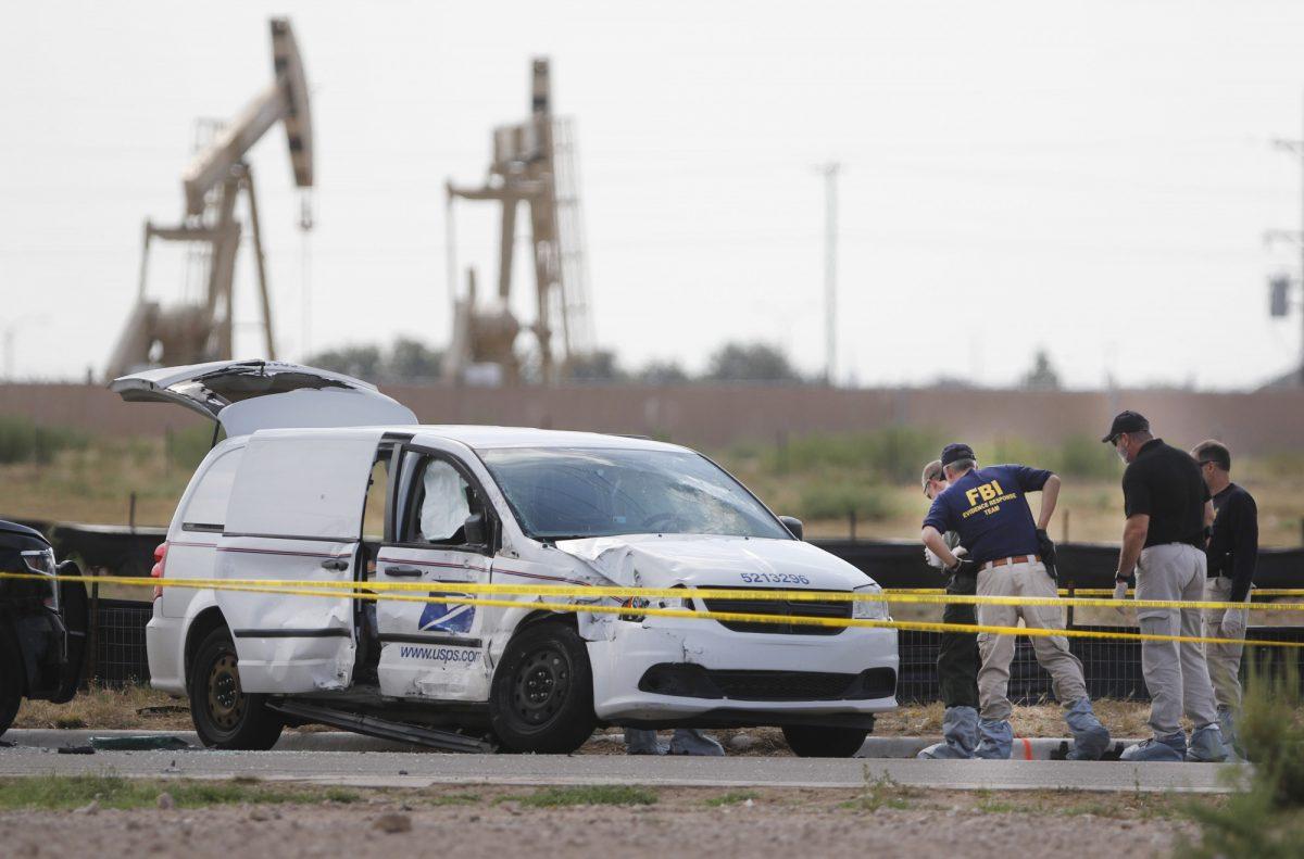 Authorities look at a U.S. Mail vehicle, which was involved in Saturday's shooting, outside the Cinergy entertainment center on Sept. 1, 2019, in Odessa, Texas. (Mark Rogers/Odessa American via AP)