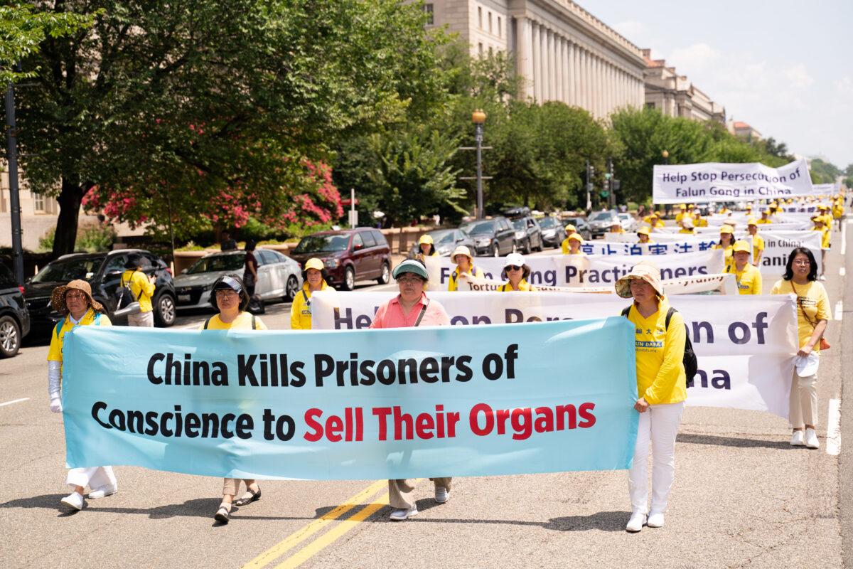 Falun Gong practitioners take part in a parade marking the 22nd anniversary of the start of the Chinese regime’s persecution of Falun Gong, in Washington on July 16, 2021. (Larry Dye/The Epoch Times)